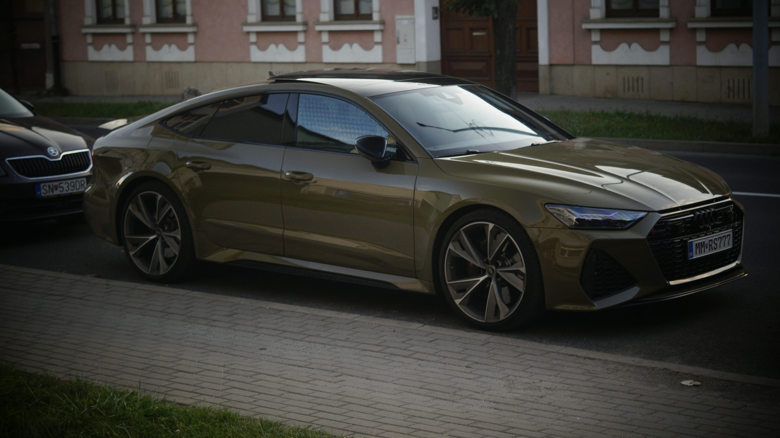 A brown sports car parked on the side of the road