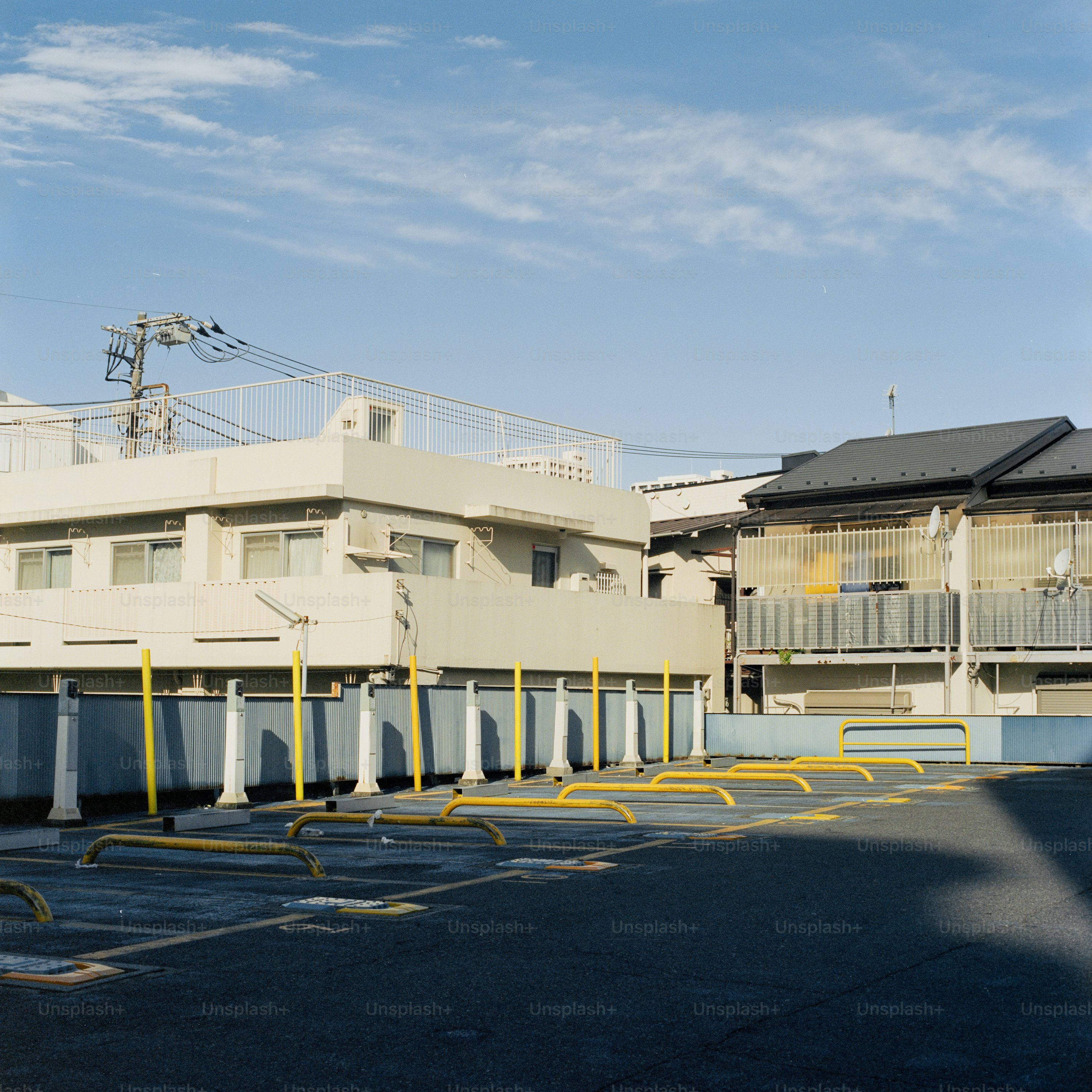 Buildings and parking lot on a sunny day.