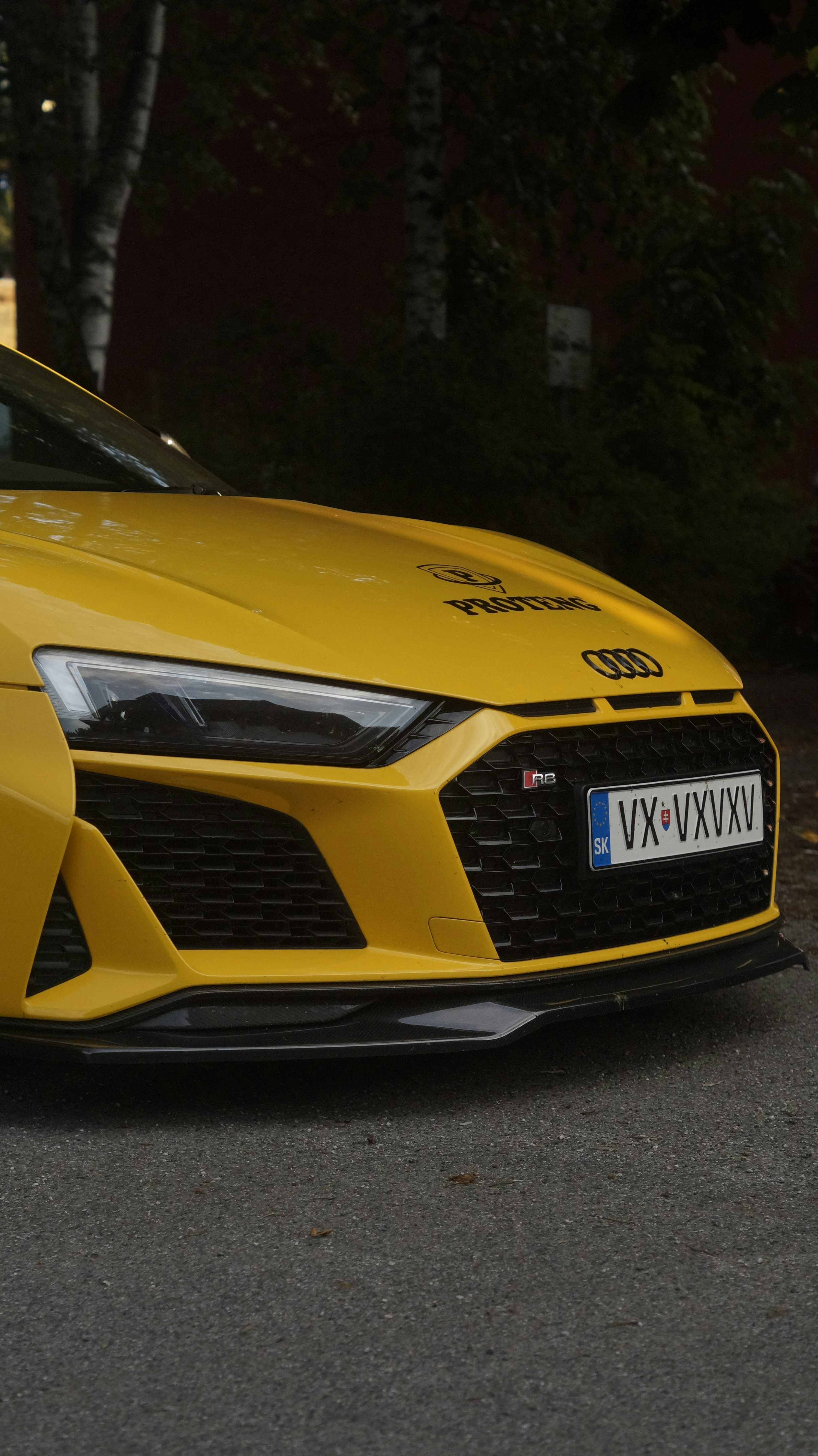 A yellow sports car parked on the side of the road