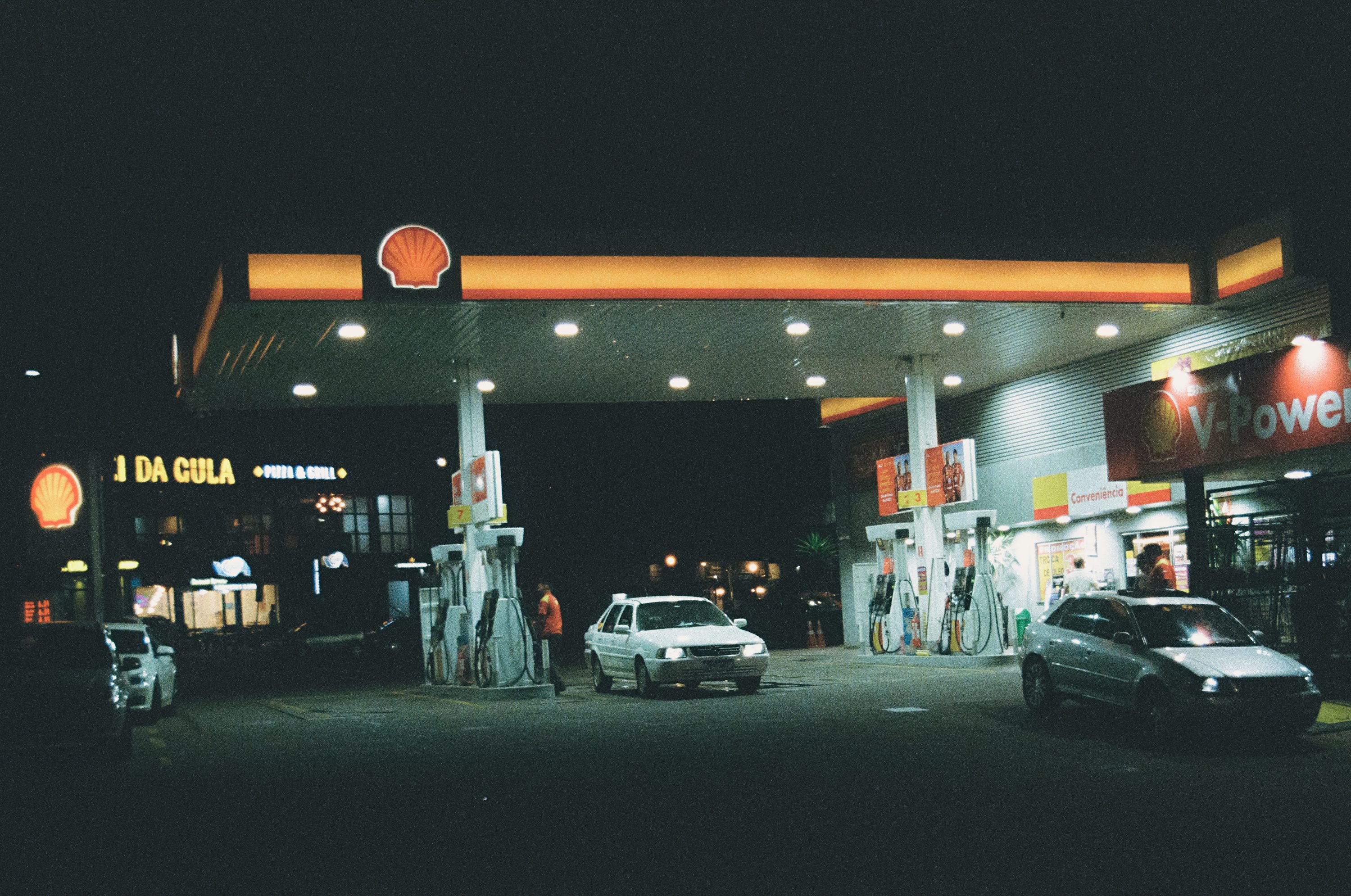 Gas station at night with cars refueling