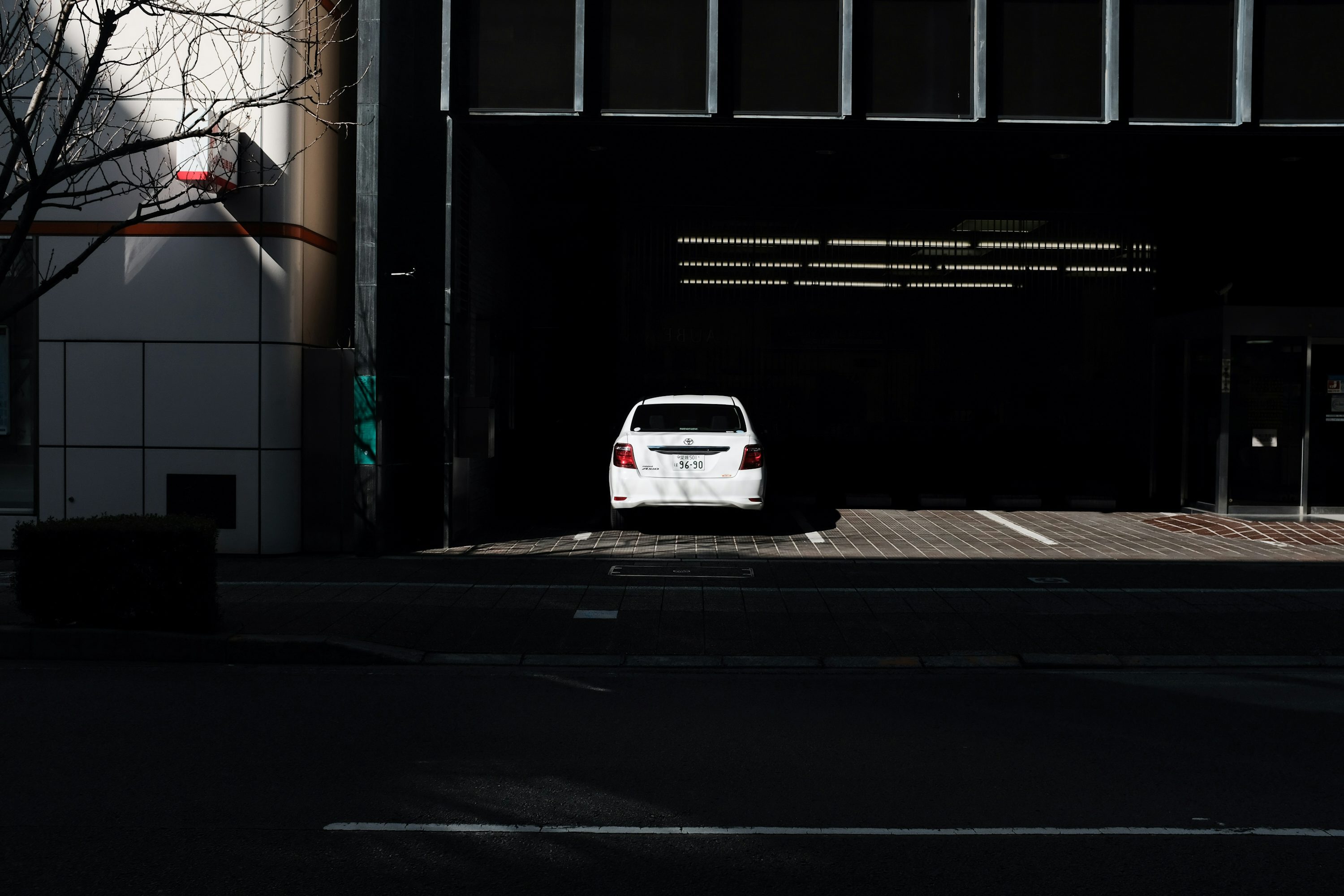 white car parked beside building