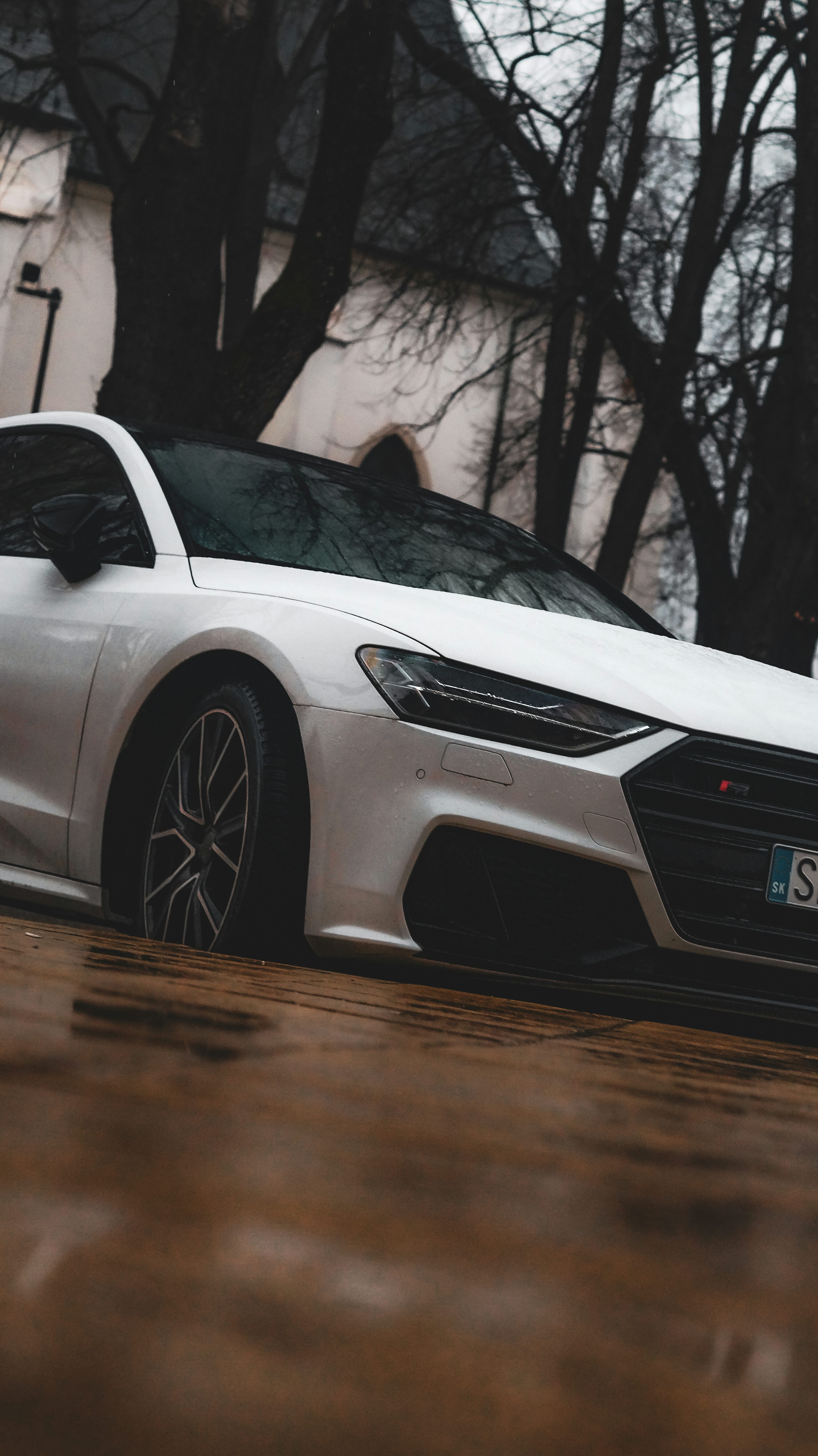a white sports car parked in front of a building