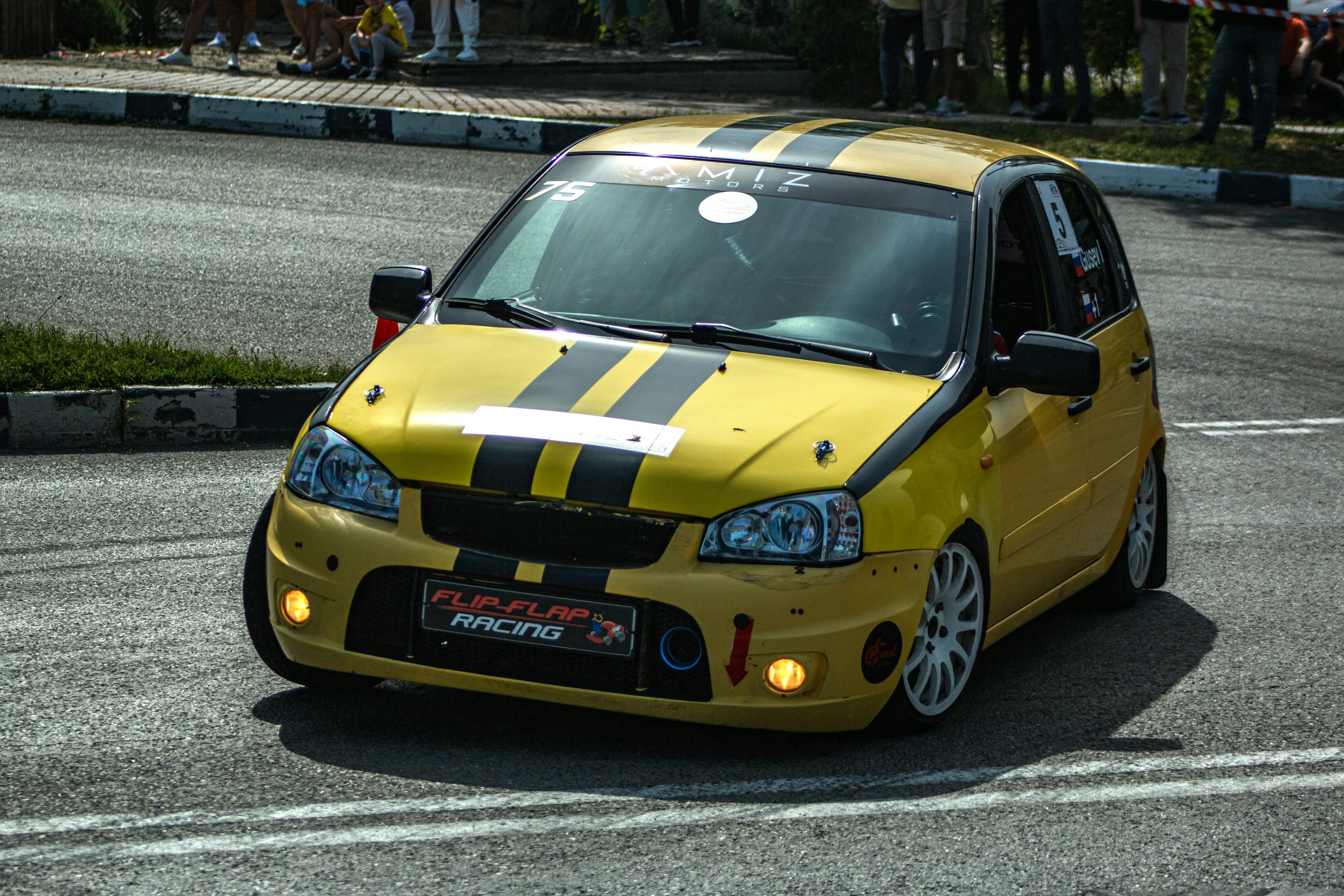 Yellow sports car with black stripes.