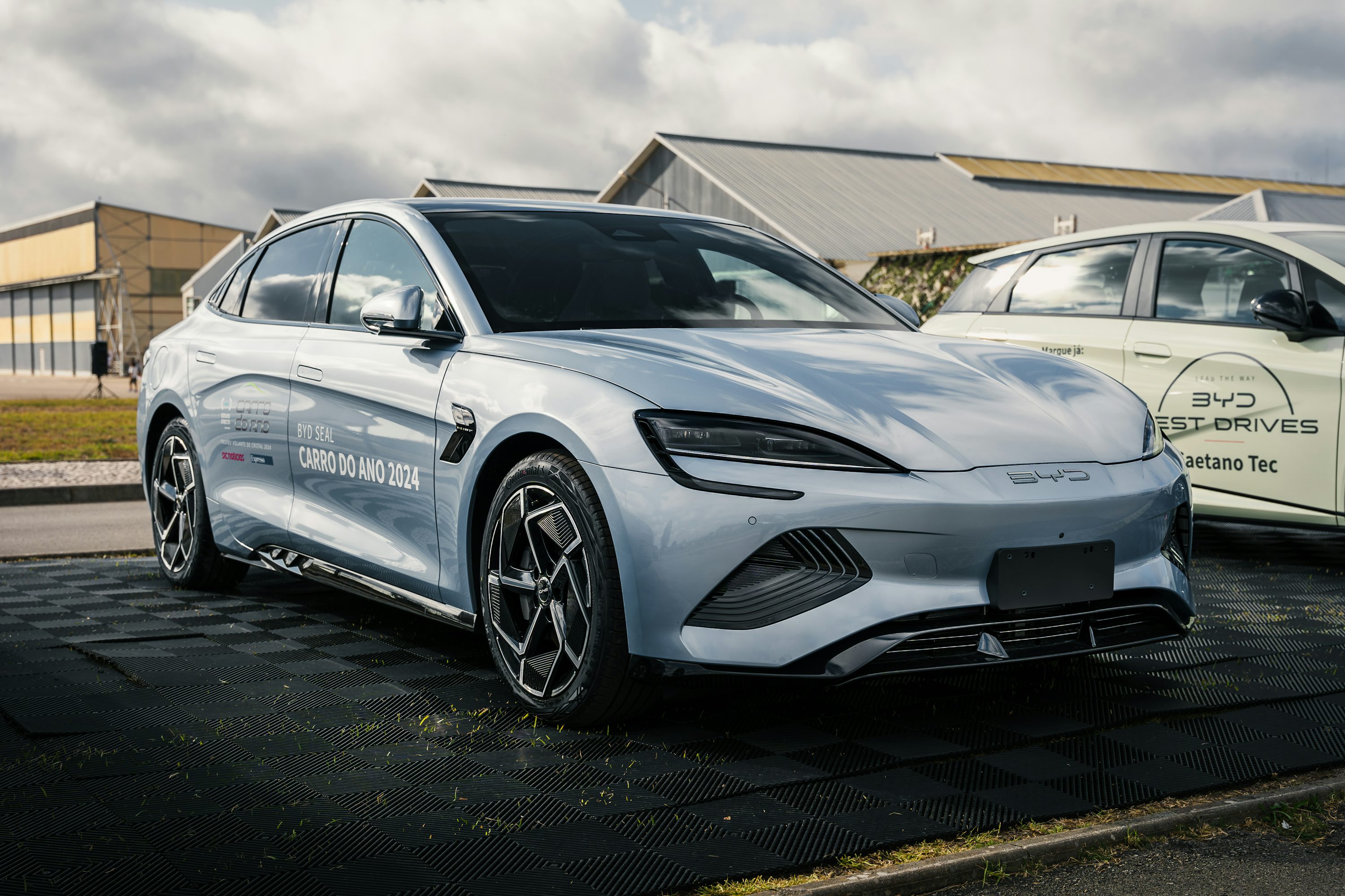 Two cars parked in a parking lot next to a building