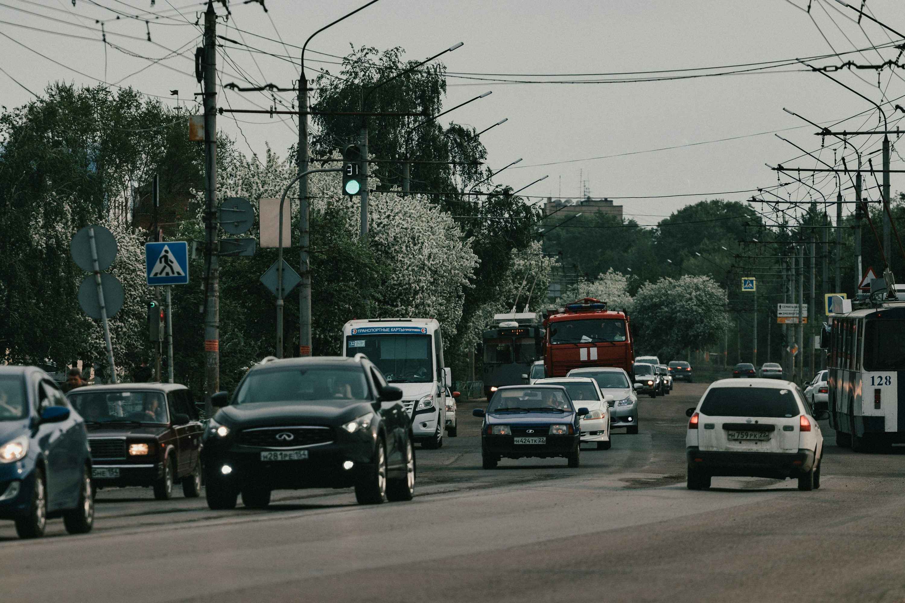 a street filled with lots of traffic next to power lines