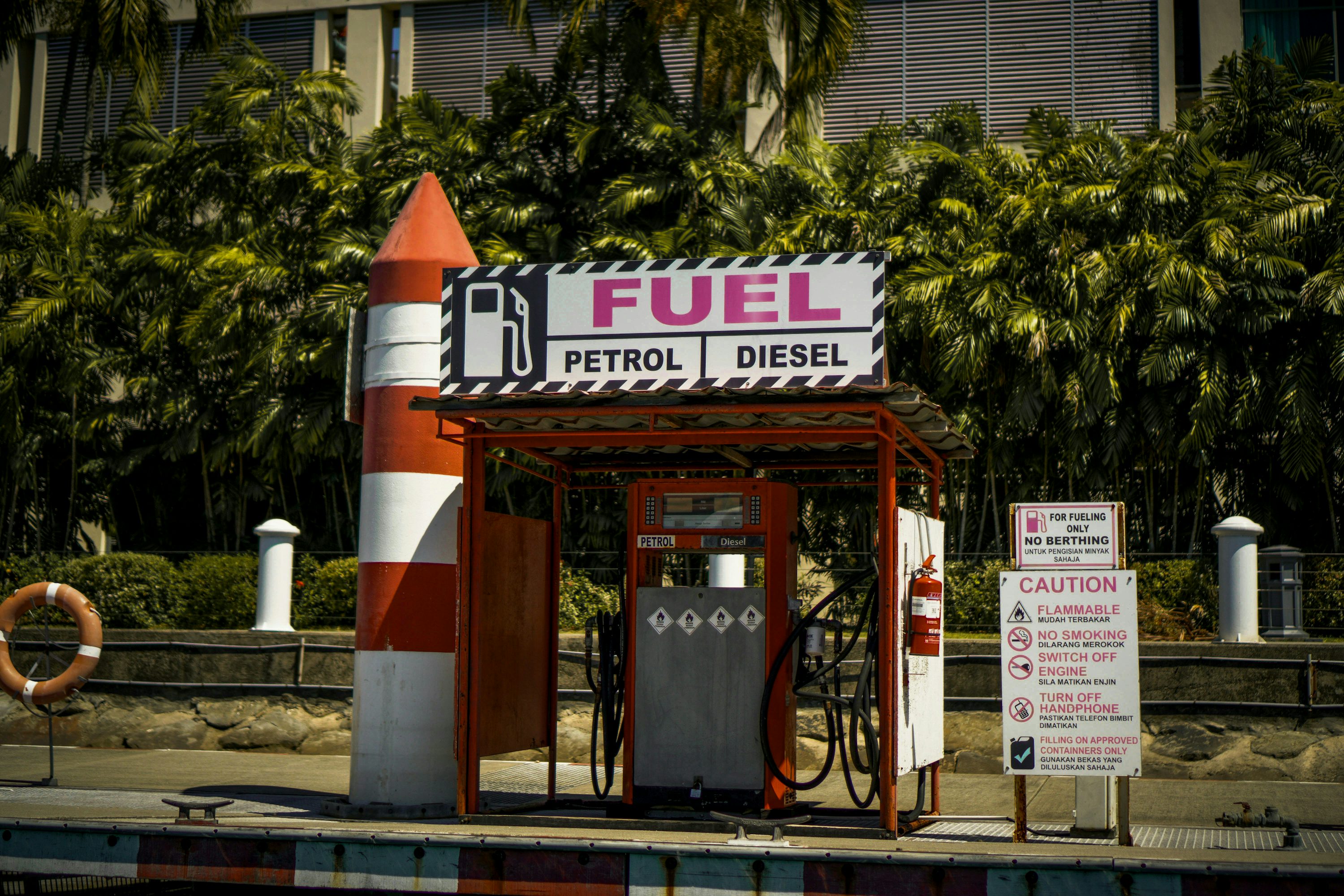 a gas station with a rocket on top of it