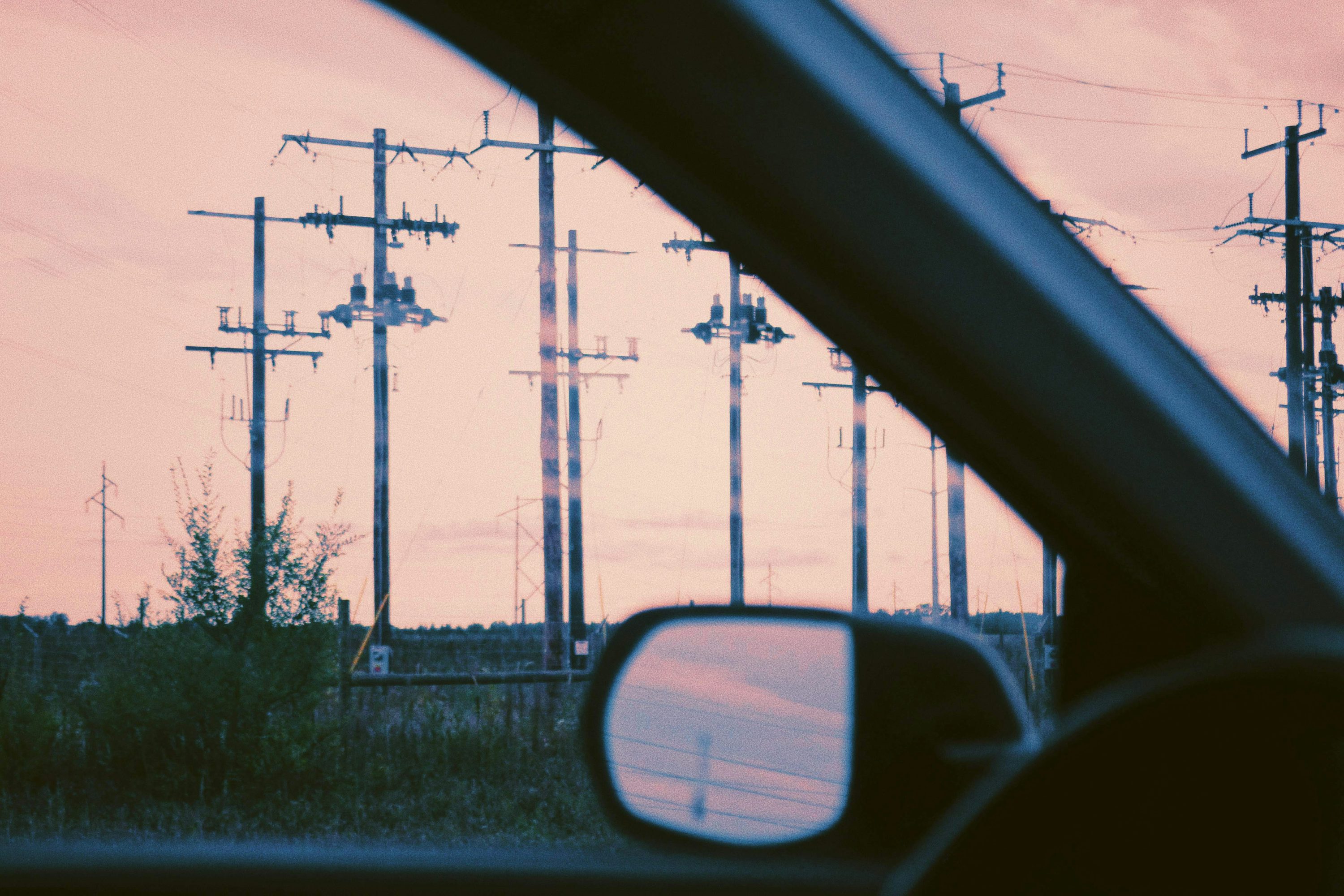 a car mirror showing a road