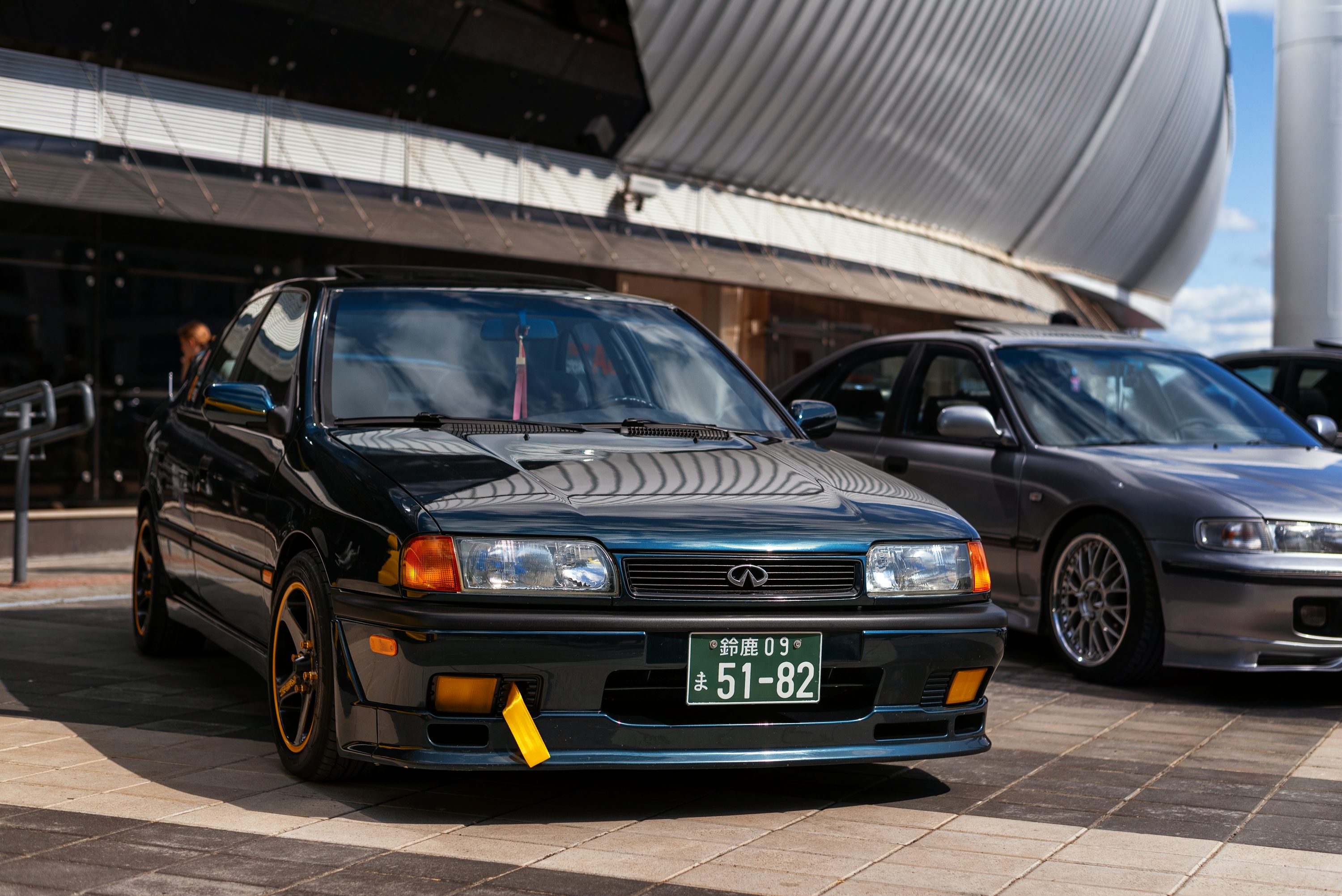 two cars parked next to each other in front of a building