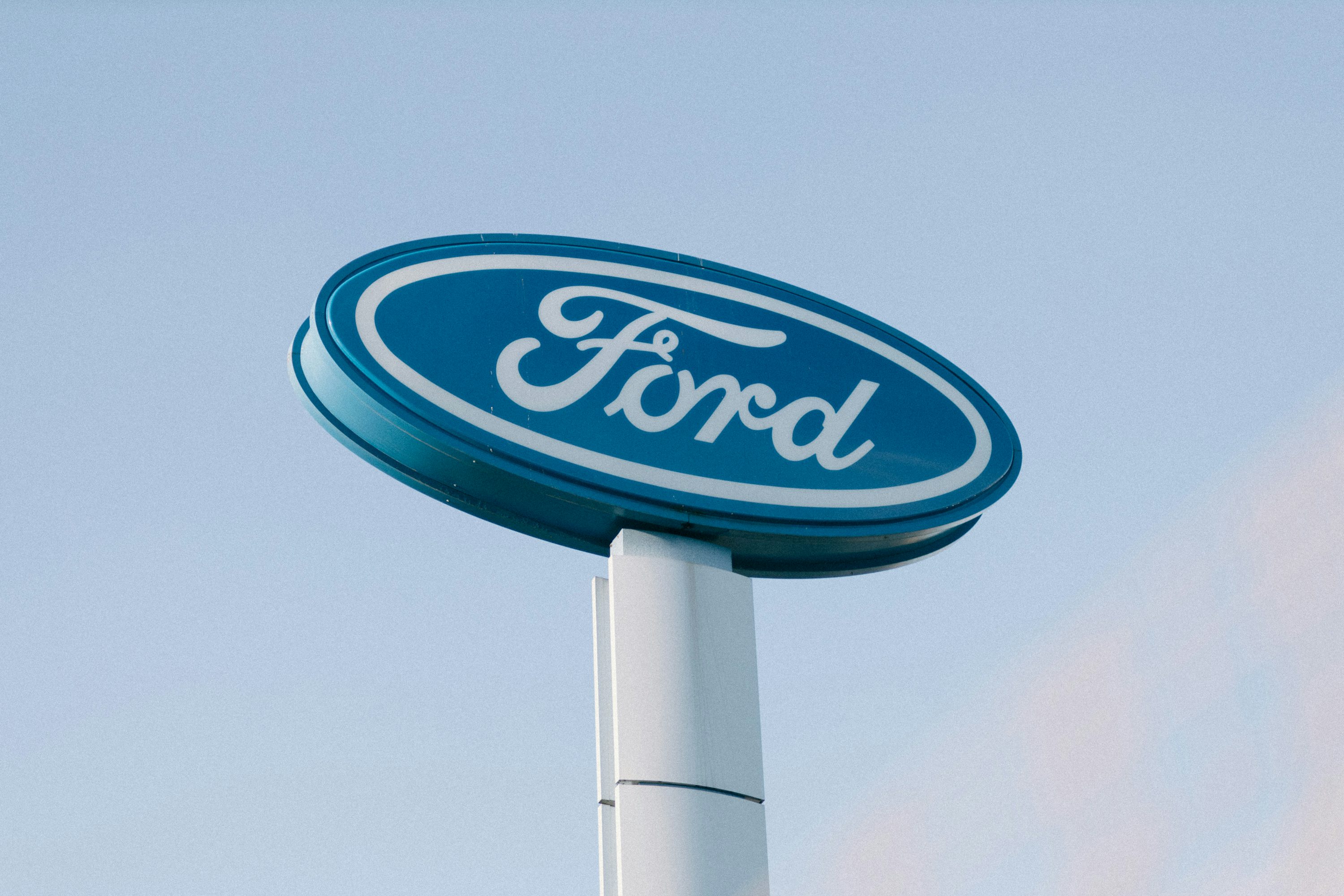 a ford sign is shown against a blue sky
