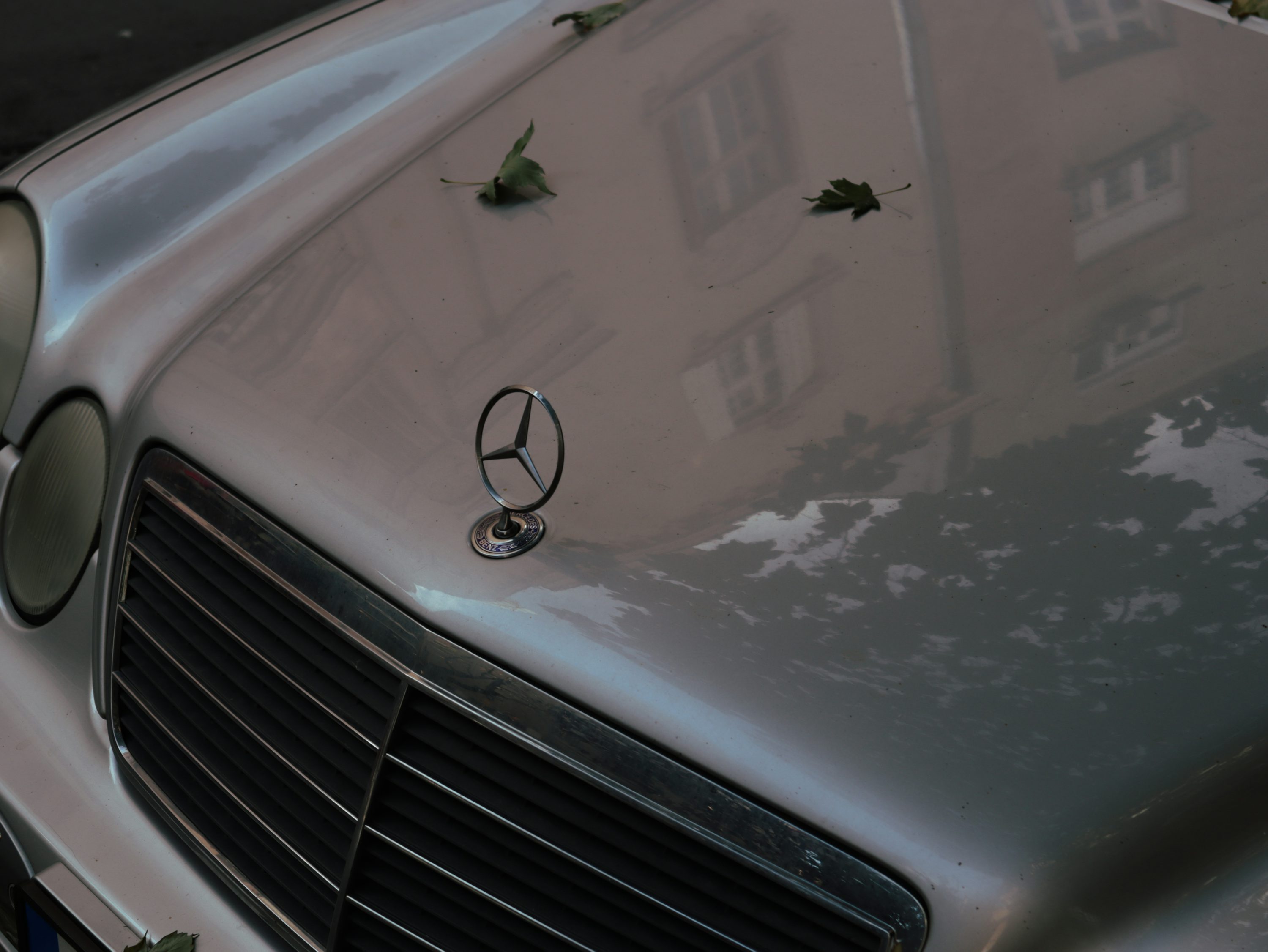 a mercedes benz is parked in front of a building