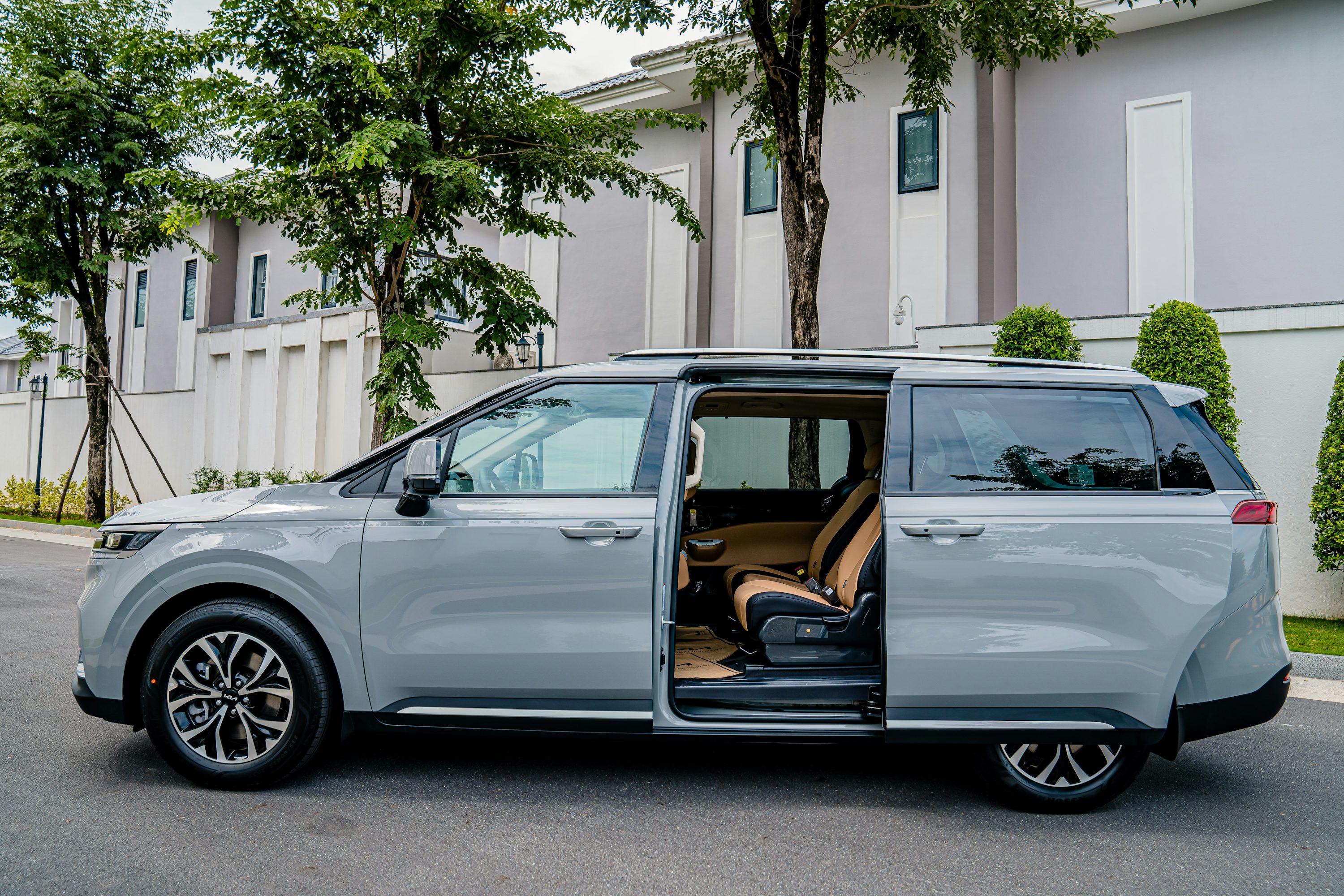 a silver minivan parked on the side of the road