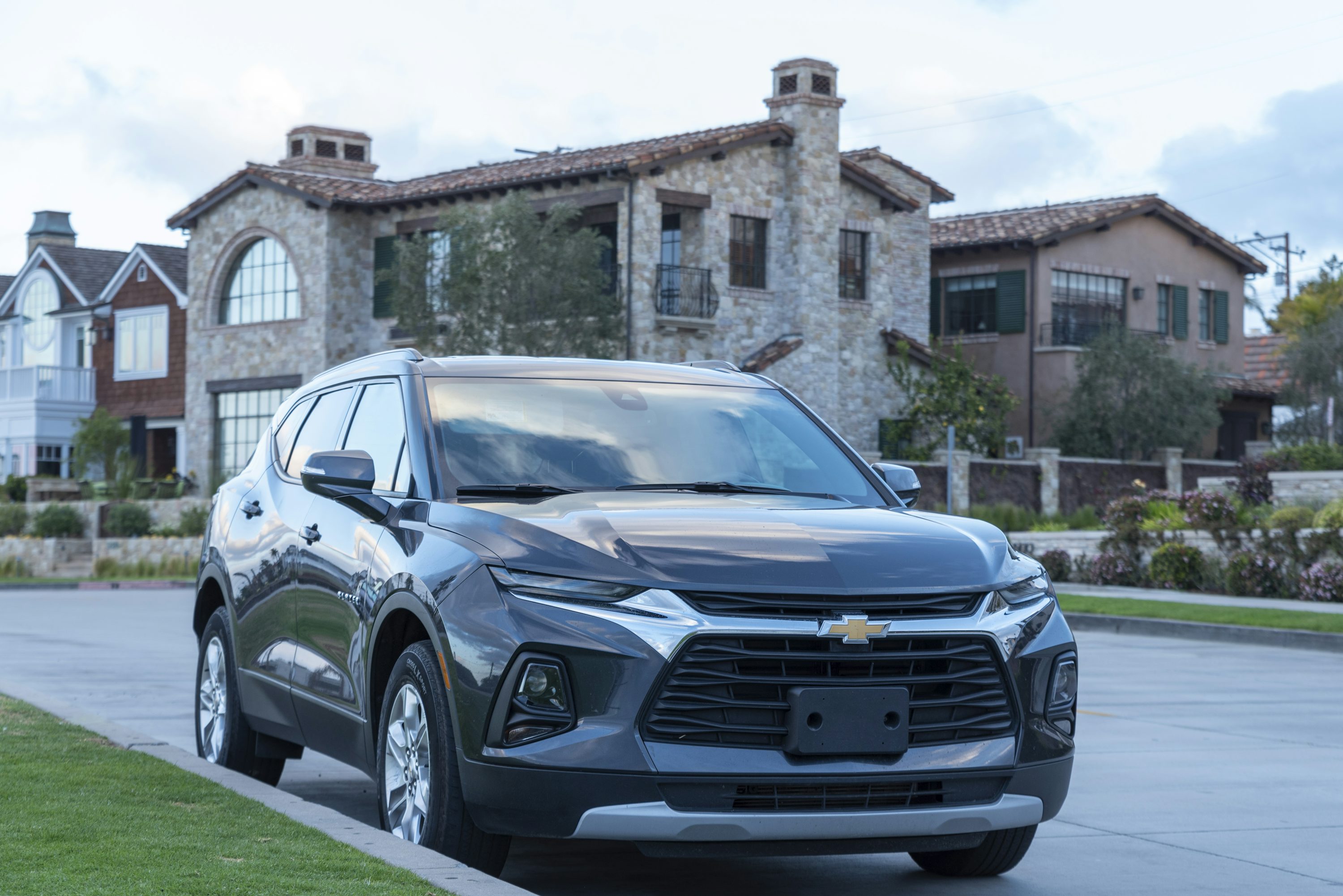 a silver chevrolet suv parked in front of a house