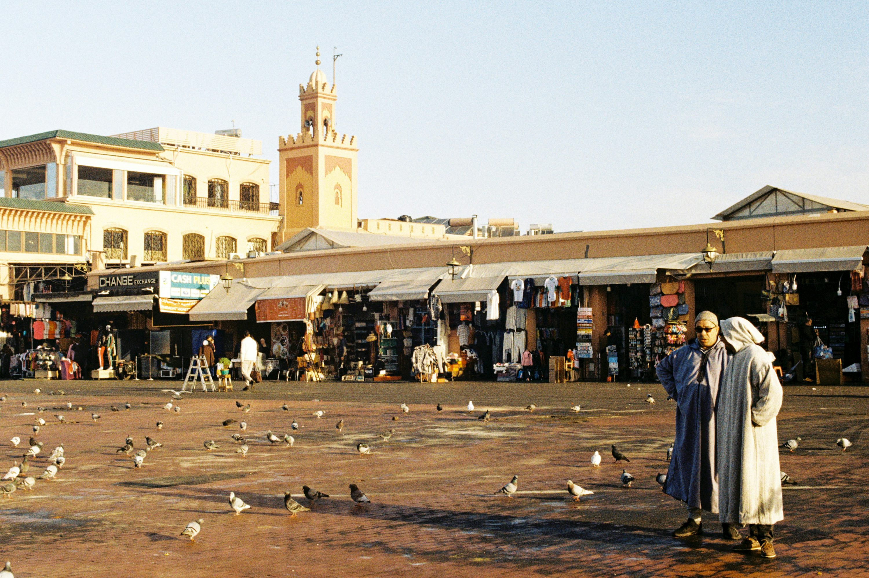 A group of people standing in front of a market