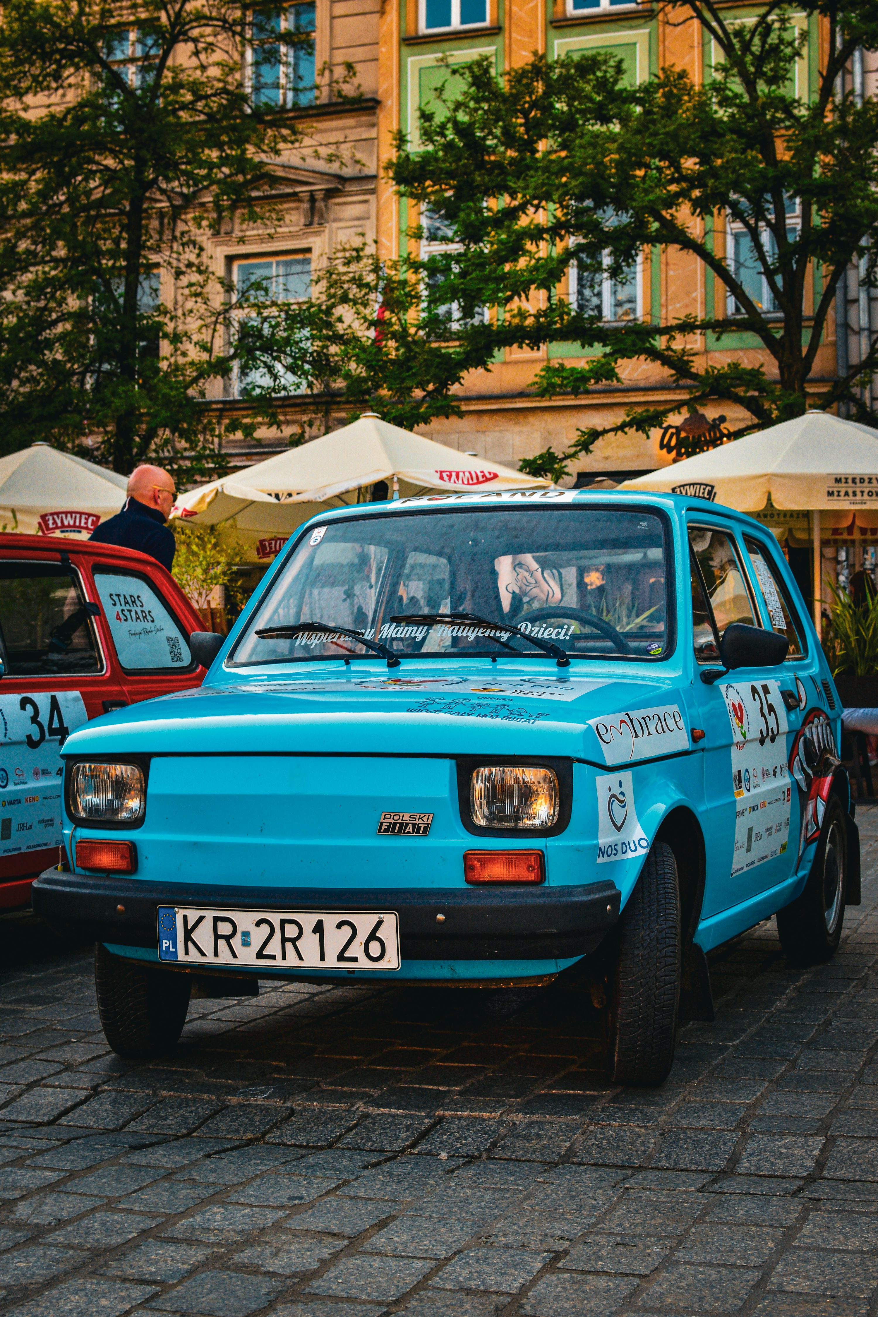 A blue car parked in front of a building