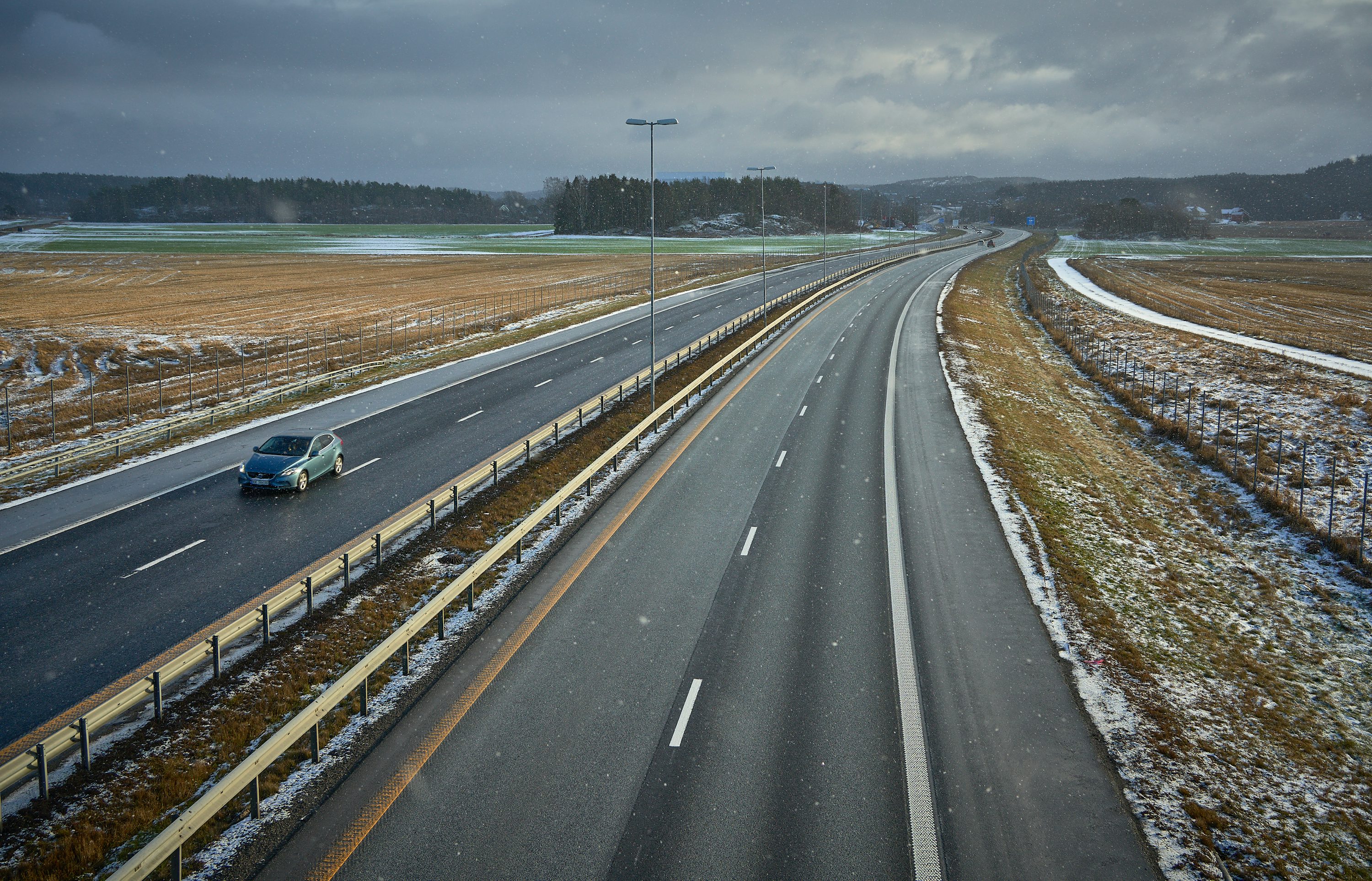 blue car on gray asphalt road during daytime