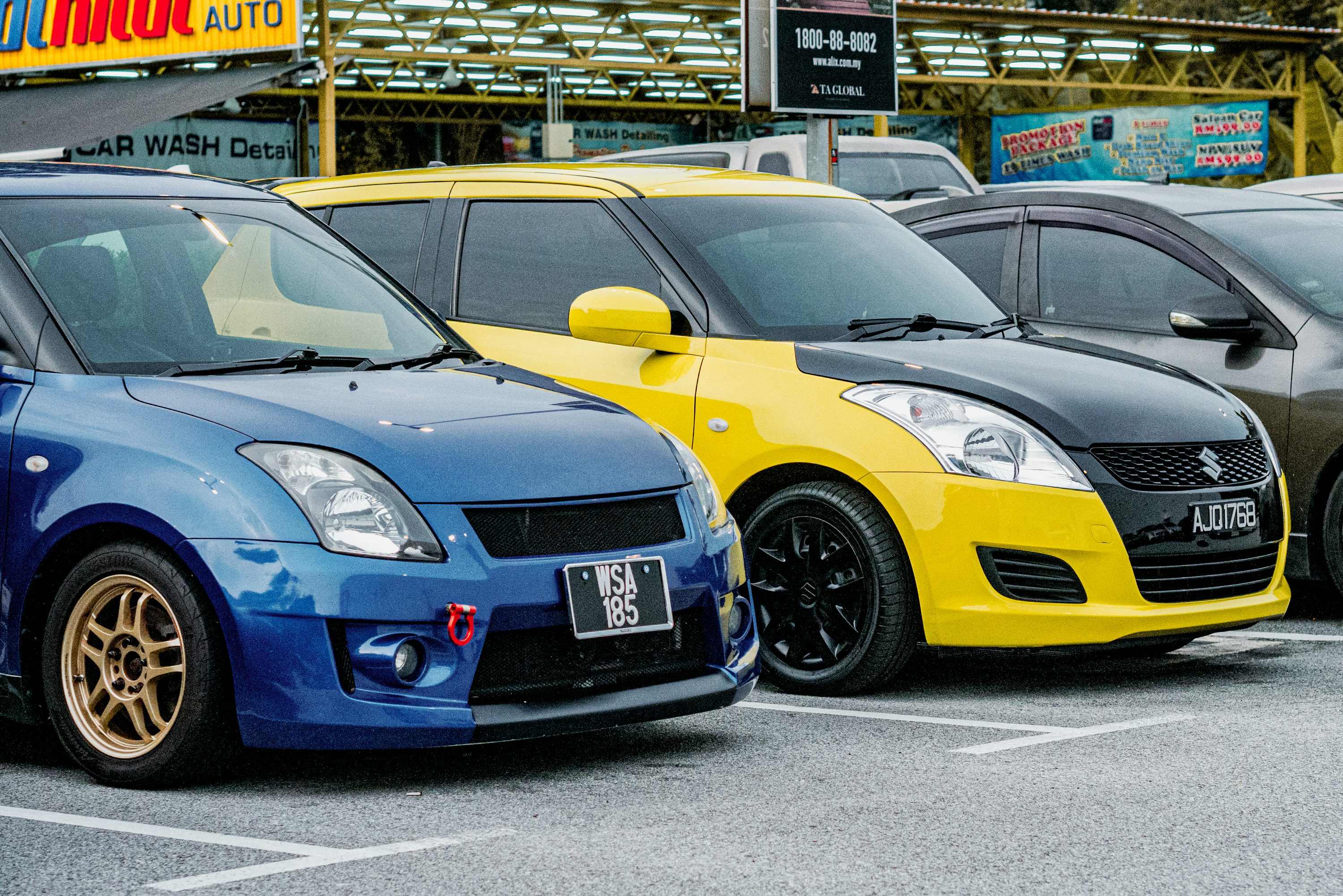 a row of cars parked in a parking lot