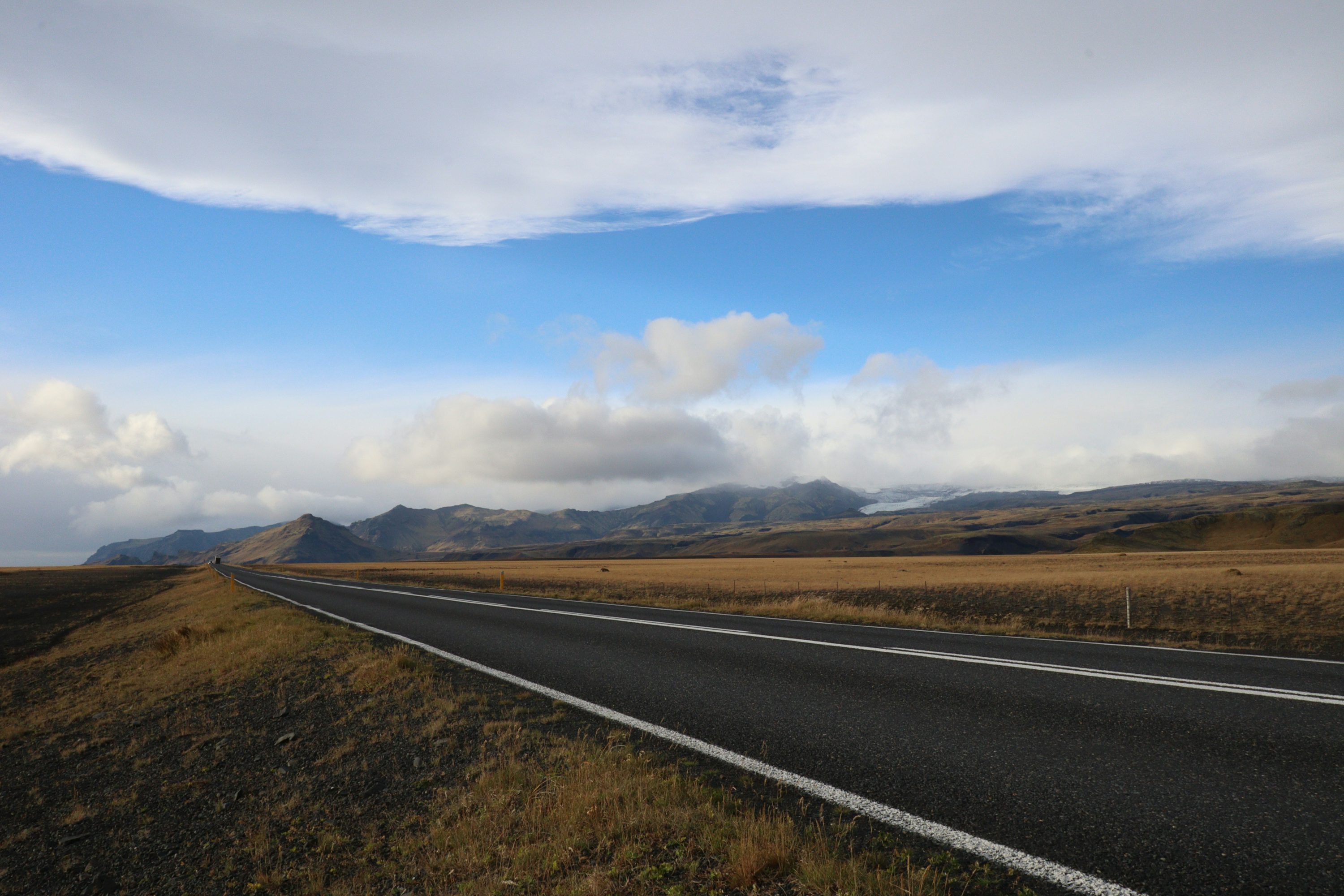 a road with mountains in the background
