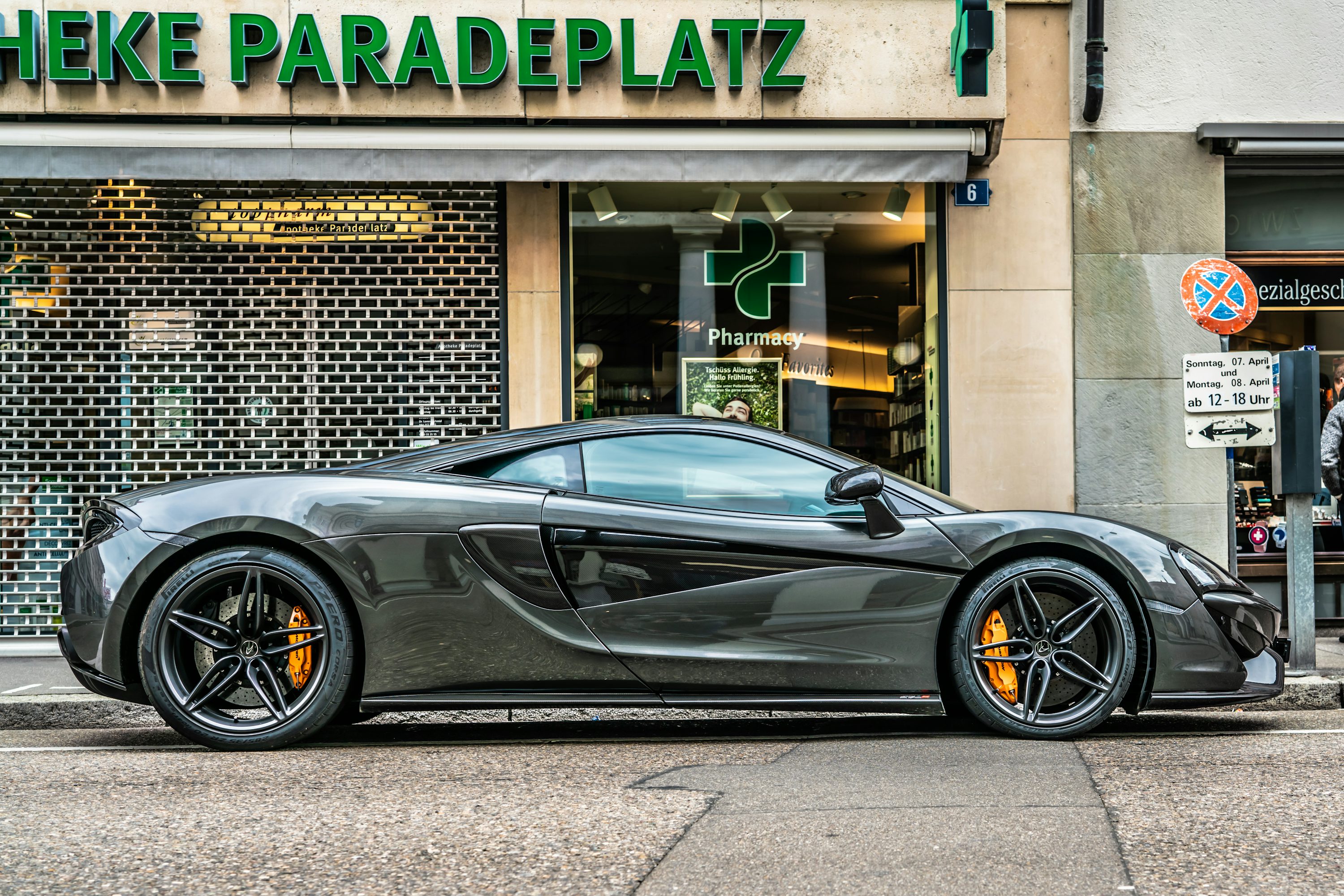 gray sports coupe parking beside store