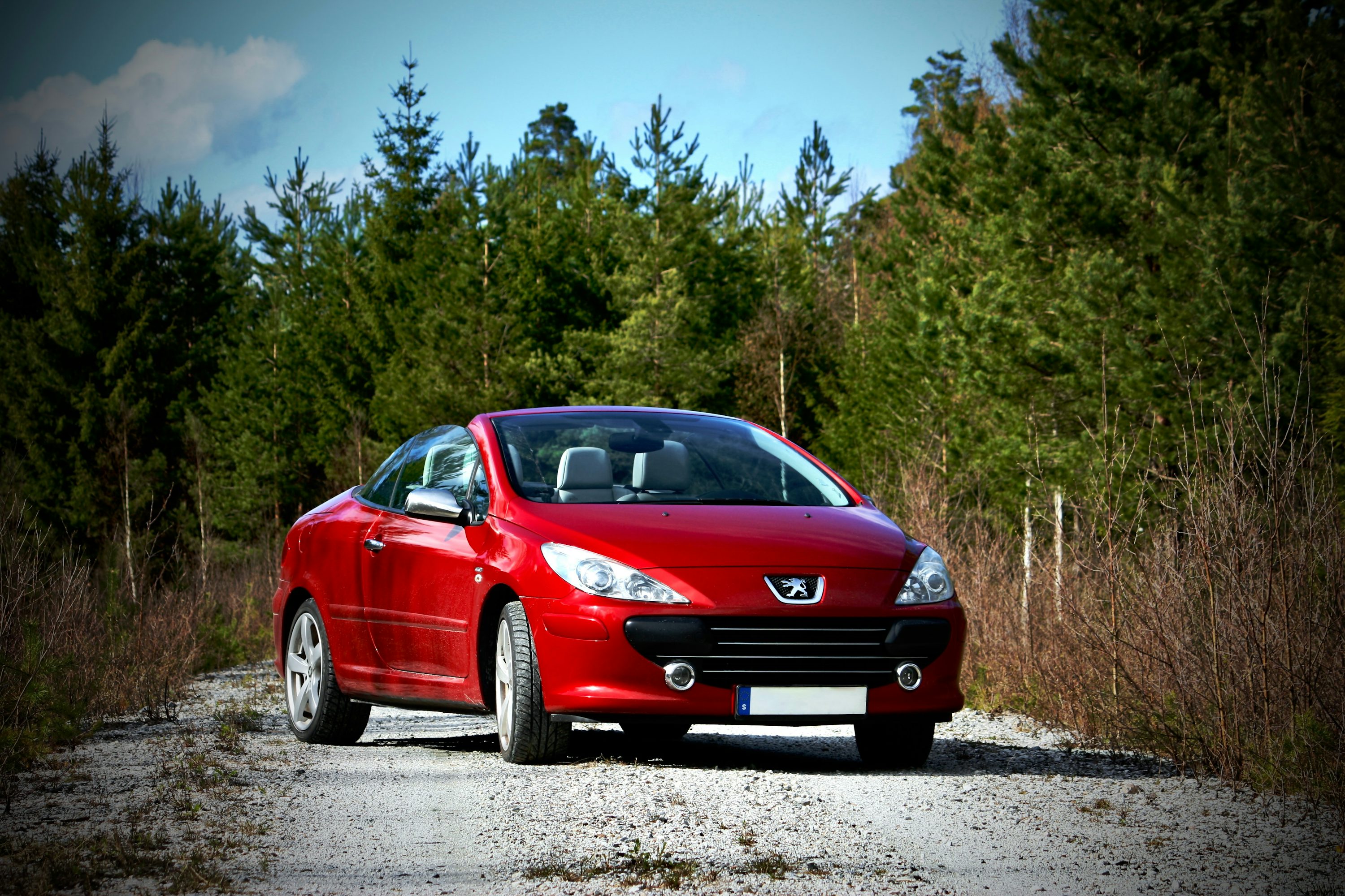 A red car parked on the side of a road
