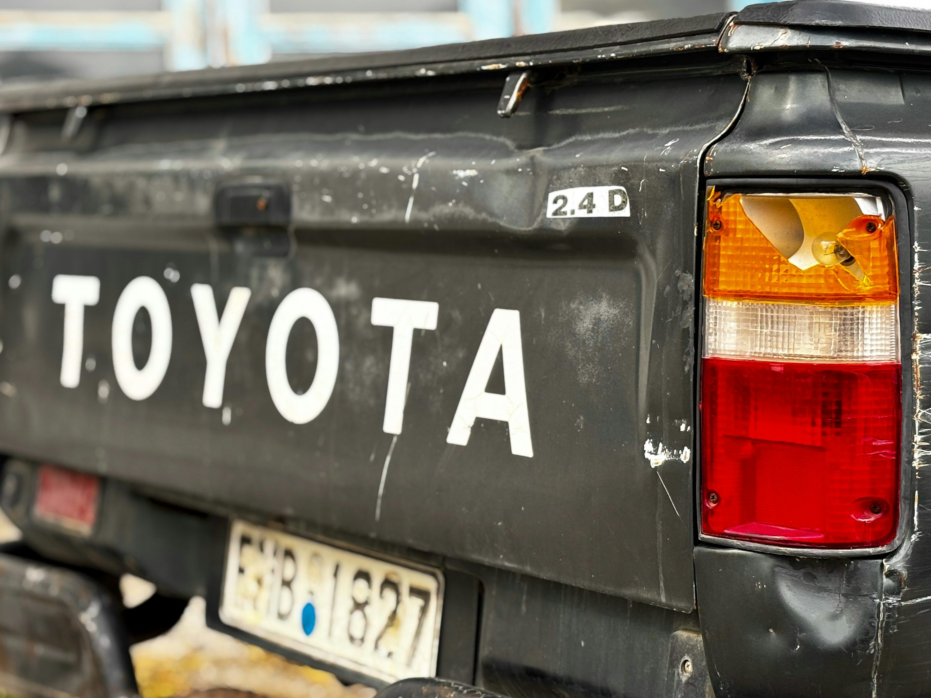 Close-up of a dusty black toyota truck tailgate.