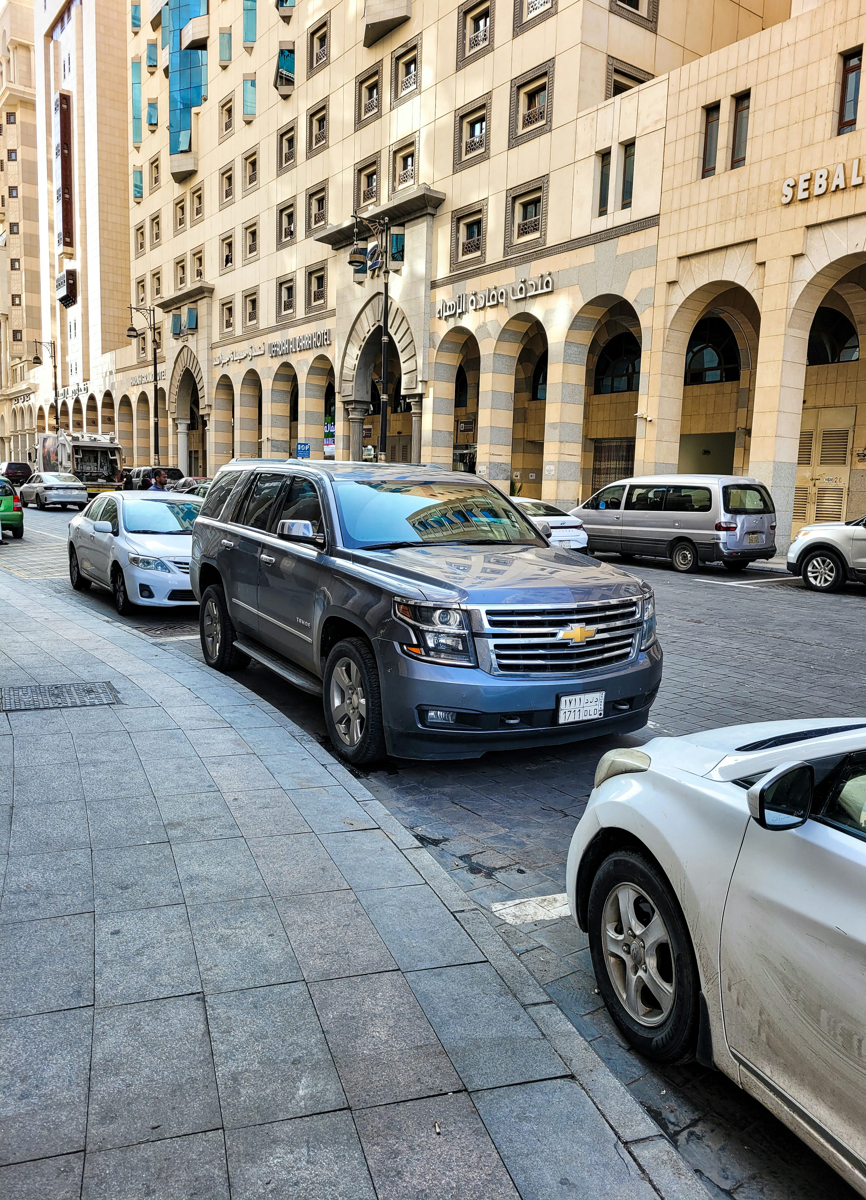 several cars parked on the side of a street