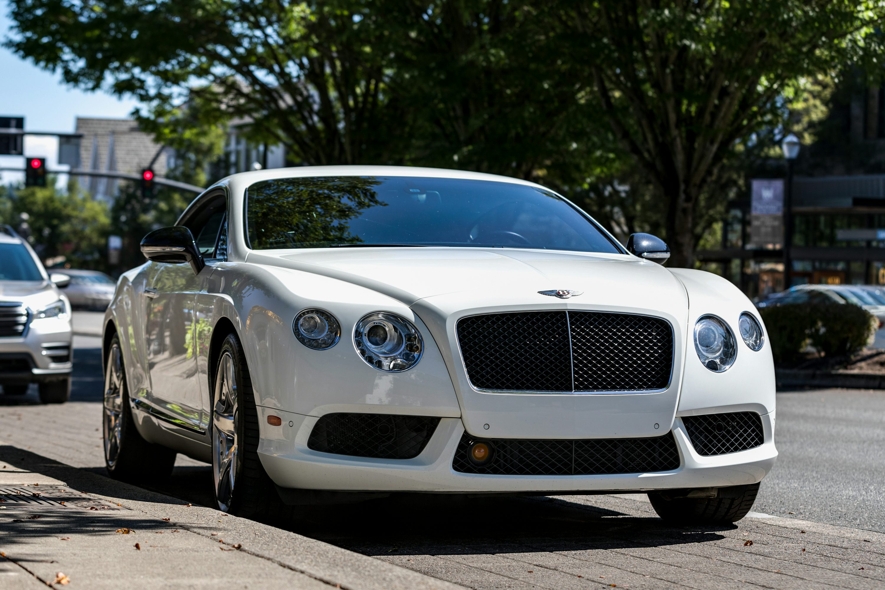 white coupe on road